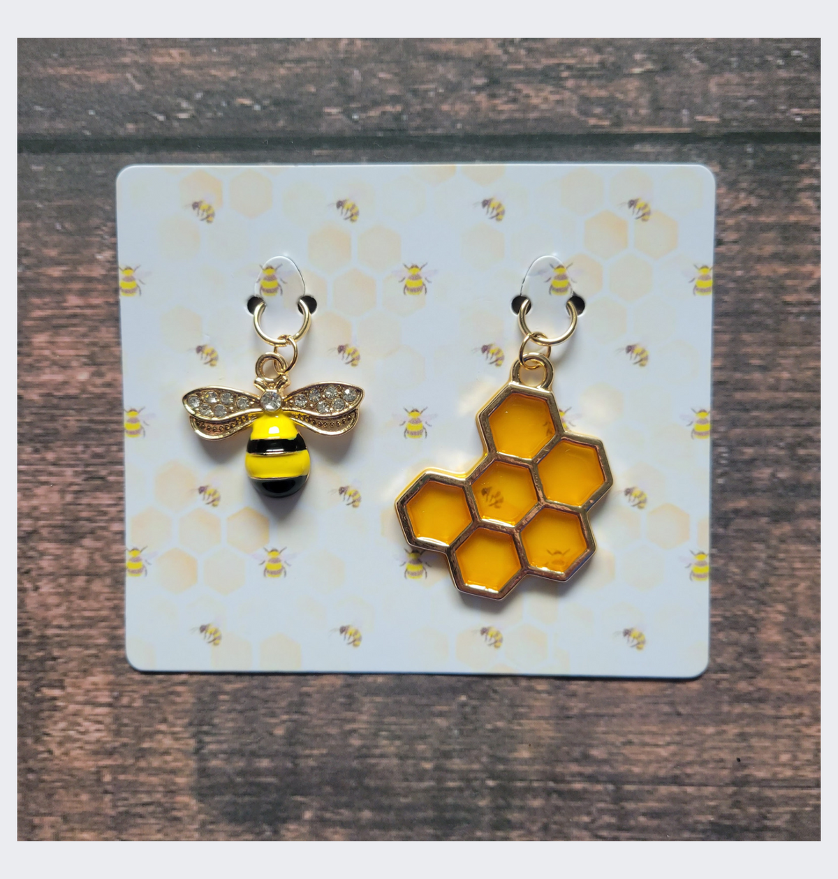 Bee and honeycomb stitch markers on a honeycomb print card