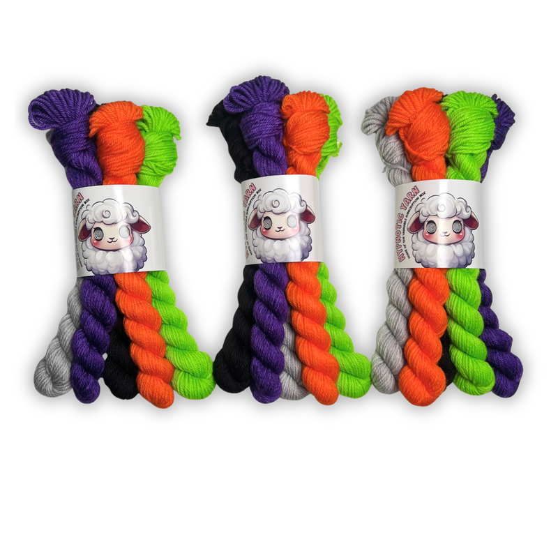 Three October 2026 Staff Pick DK mini sets standing side by side in purple, orange, lime green, black and light gray