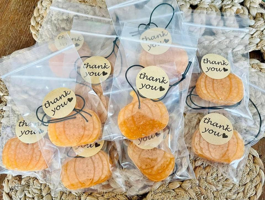 Orange pumpkin shaped car freshies in clear bags with thank you tags