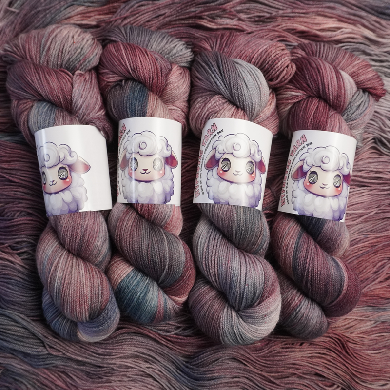 Twisted skeins of hand-dyed yarn featuring blended plum, blush, and slate gray colors, shown with illustrated sheep labels.