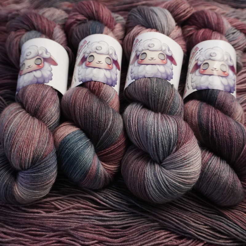 Twisted skeins of hand-dyed yarn featuring blended plum, blush, and slate gray colors, shown with illustrated sheep labels.