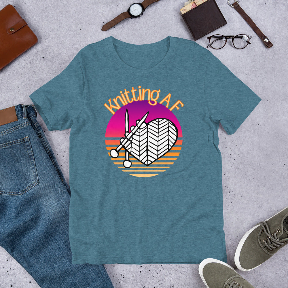 Heather deep teal scoop neck tee with the Knitting AF design in magenta and orange sunset stripes with knitting needles