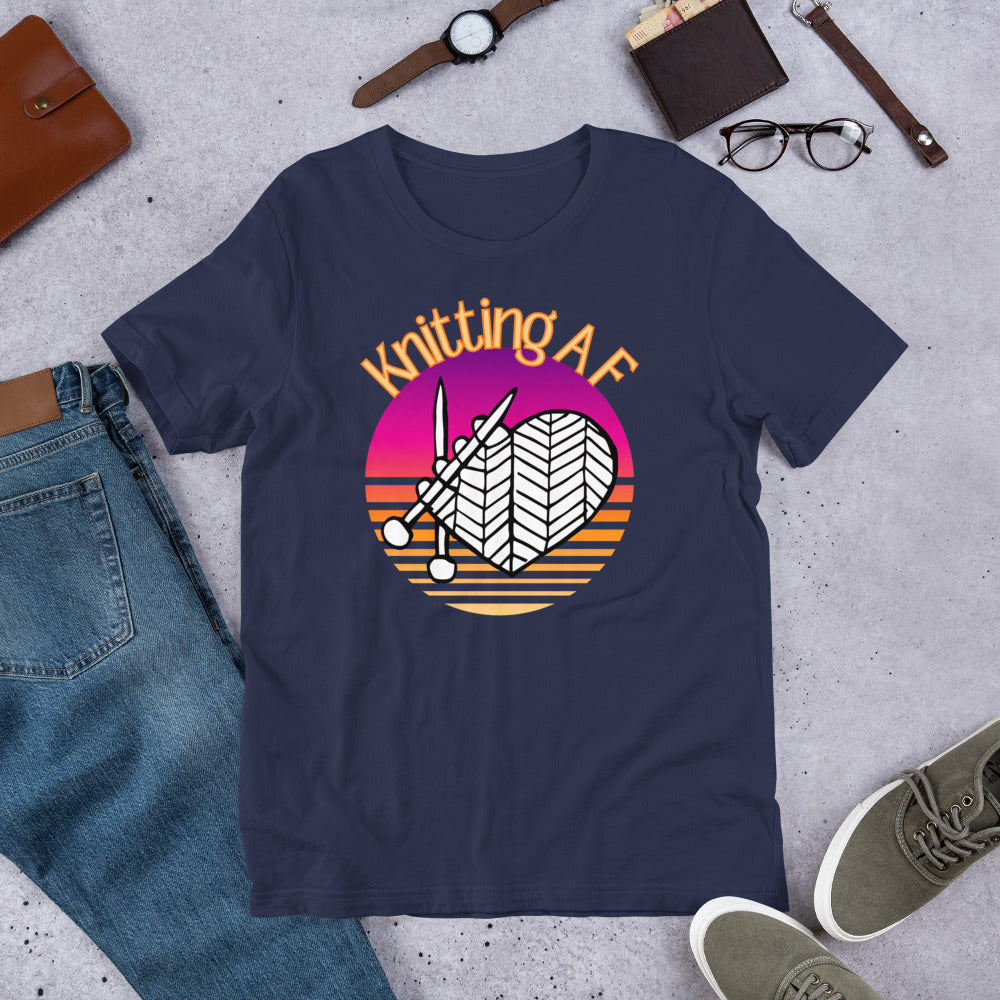 Navy scoop neck tee with the Knitting AF design in magenta and orange sunset stripes with knitting needles